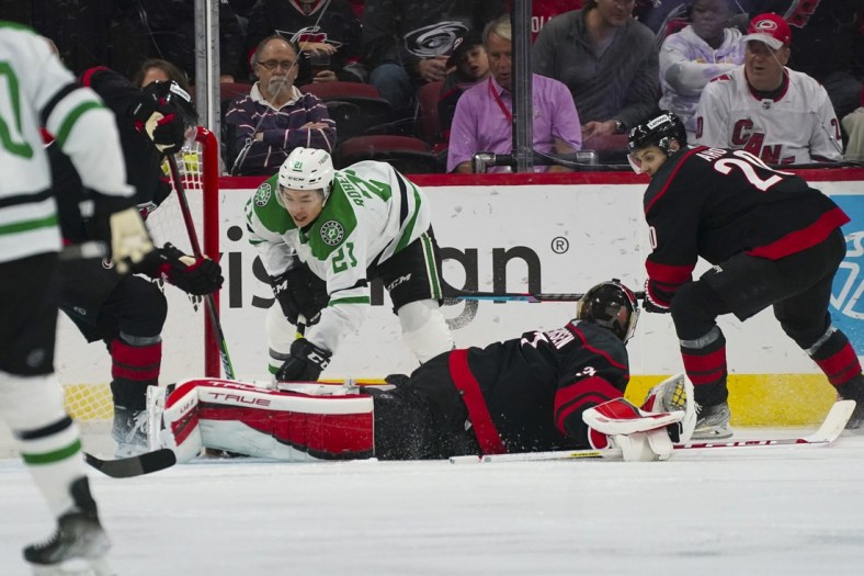 Mar 24, 2022; Raleigh, North Carolina, USA;  Carolina Hurricanes goaltender Frederik Andersen (31) stops the shot by Dallas Stars left wing Jason Robertson (21) during the first period at PNC Arena. Mandatory Credit: James Guillory-USA TODAY Sports