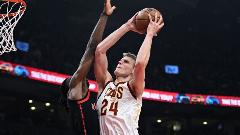 Mar 24, 2022; Toronto, Ontario, CAN;   Cleveland Cavaliers forward Lauri Markkanen (24) shoots for a basket against Toronto Raptors forward Precious Achiuwa (5) in the first half at Scotiabank Arena. Mandatory Credit: Dan Hamilton-USA TODAY Sports