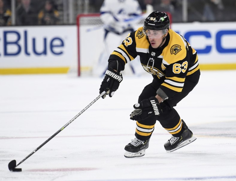Mar 24, 2022; Boston, Massachusetts, USA;  Boston Bruins left wing Brad Marchand (63) controls the puck during the second period against the Tampa Bay Lightning at TD Garden. Mandatory Credit: Bob DeChiara-USA TODAY Sports