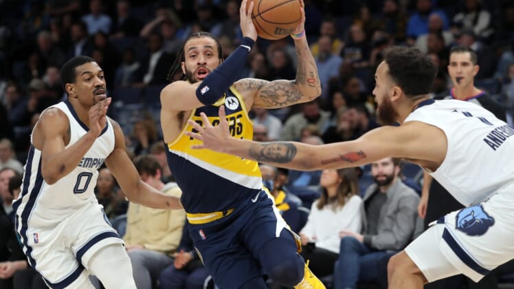 Mar 24, 2022; Memphis, Tennessee, USA; Indiana Pacers guard Duane Washington Jr. (4) drives to the basket as Memphis Grizzlies guard De'Anthony Melton (0) and guard Kyle Anderson (1) defend during the first half at FedExForum. Mandatory Credit: Petre Thomas-USA TODAY Sports