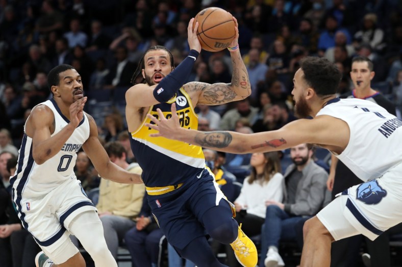 Mar 24, 2022; Memphis, Tennessee, USA; Indiana Pacers guard Duane Washington Jr. (4) drives to the basket as Memphis Grizzlies guard De'Anthony Melton (0) and guard Kyle Anderson (1) defend during the first half at FedExForum. Mandatory Credit: Petre Thomas-USA TODAY Sports