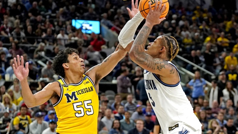 Mar 24, 2022; San Antonio, TX, USA; Villanova Wildcats guard Justin Moore (5) drives to the basket against Michigan Wolverines guard Eli Brooks (55) in the semifinals of the South regional of the men's college basketball NCAA Tournament at AT&T Center. Mandatory Credit: Scott Wachter-USA TODAY Sports