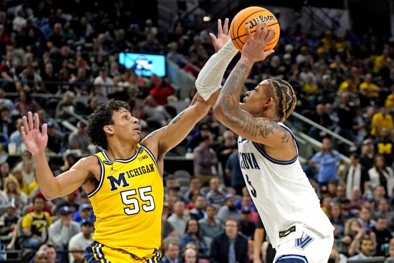 Mar 24, 2022; San Antonio, TX, USA; Villanova Wildcats guard Justin Moore (5) drives to the basket against Michigan Wolverines guard Eli Brooks (55) in the semifinals of the South regional of the men's college basketball NCAA Tournament at AT&T Center. Mandatory Credit: Scott Wachter-USA TODAY Sports