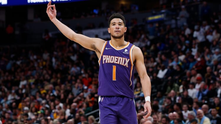 Mar 24, 2022; Denver, Colorado, USA; Phoenix Suns guard Devin Booker (1) gestures to the crowd in the fourth quarter against the Denver Nuggets at Ball Arena. Mandatory Credit: Isaiah J. Downing-USA TODAY Sports