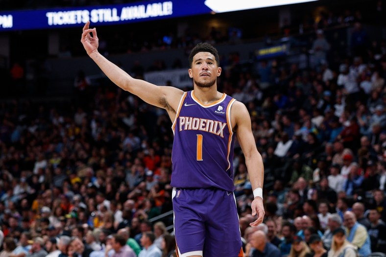 Mar 24, 2022; Denver, Colorado, USA; Phoenix Suns guard Devin Booker (1) gestures to the crowd in the fourth quarter against the Denver Nuggets at Ball Arena. Mandatory Credit: Isaiah J. Downing-USA TODAY Sports