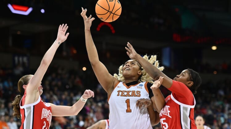 Mar 25, 2022; Spokane, WA, USA; Texas Longhorns center Lauren Ebo (1) tries to catch a pass against Ohio State Buckeyes forward Tanaya Beacham (35)and Ohio State Buckeyes guard Taylor Mikesell (24) in the Spokane regional semifinals of the women's college basketball NCAA Tournament at Spokane Veterans Memorial Arena. Mandatory Credit: James Snook-USA TODAY Sports