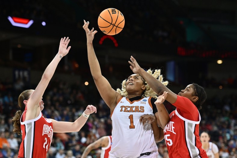 Mar 25, 2022; Spokane, WA, USA; Texas Longhorns center Lauren Ebo (1) tries to catch a pass against Ohio State Buckeyes forward Tanaya Beacham (35)and Ohio State Buckeyes guard Taylor Mikesell (24) in the Spokane regional semifinals of the women's college basketball NCAA Tournament at Spokane Veterans Memorial Arena. Mandatory Credit: James Snook-USA TODAY Sports