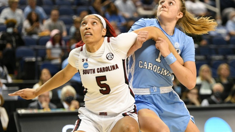 Mar 25, 2022; Greensboro, NC, USA; South Carolina Gamecocks forward Victaria Saxton (5) and North Carolina Tar Heels guard Alyssa Ustby (1) battle for position in the second quarter in the Greensboro regional semifinals of the women's college basketball NCAA Tournament at Greensboro Coliseum. Mandatory Credit: William Howard-USA TODAY Sports