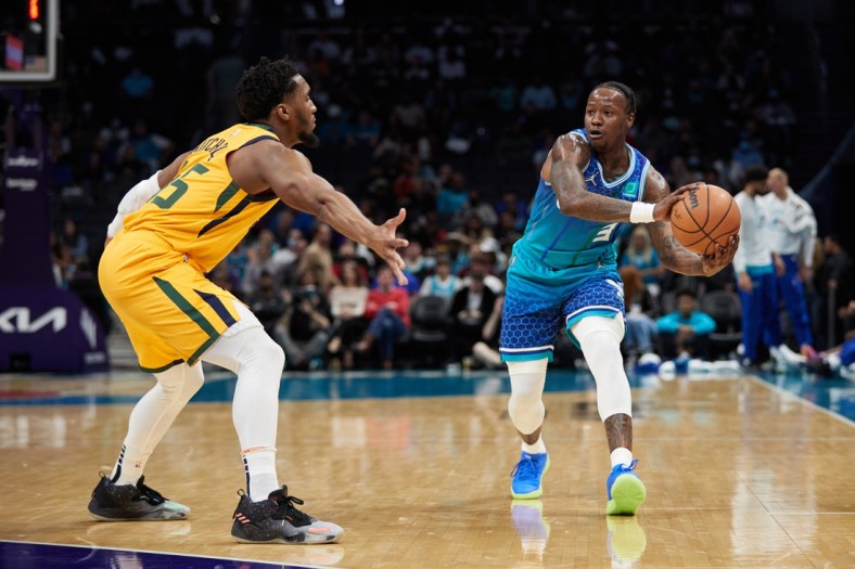 Mar 25, 2022; Charlotte, North Carolina, USA; Charlotte Hornets guard Terry Rozier (3) is guarded by Utah Jazz guard Donovan Mitchell (45) during the first quarter at Spectrum Center. Mandatory Credit: Brian Westerholt-USA TODAY Sports