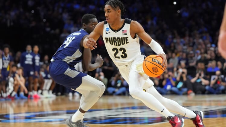 Mar 25, 2022; Philadelphia, PA, USA; Purdue Boilermakers guard Jaden Ivey (23) controls the ball against St. Peter's Peacocks forward Hassan Drame (14) in the second half in the semifinals of the East regional of the men's college basketball NCAA Tournament at Wells Fargo Center. Mandatory Credit: Mitchell Leff-USA TODAY Sports