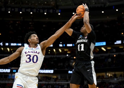 Mar 25, 2022; Chicago, IL, USA; Providence Friars guard A.J. Reeves (11) shoots over Kansas Jayhawks guard Ochai Agbaji (30) during the second half in the semifinals of the Midwest regional of the men's college basketball NCAA Tournament at United Center. Mandatory Credit: Jamie Sabau-USA TODAY Sports
