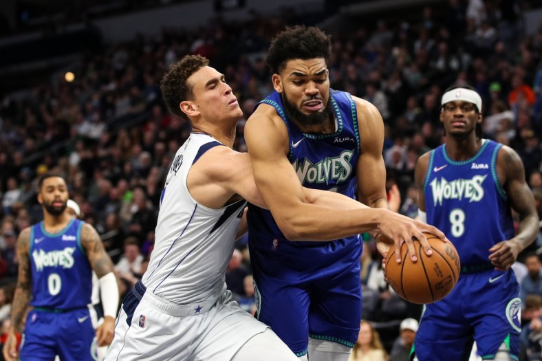 Mar 25, 2022; Minneapolis, Minnesota, USA; Dallas Mavericks center Dwight Powell (7) and Minnesota Timberwolves center Karl-Anthony Towns (32) compete for the rebound in the second quarter at Target Center. Mandatory Credit: David Berding-USA TODAY Sports