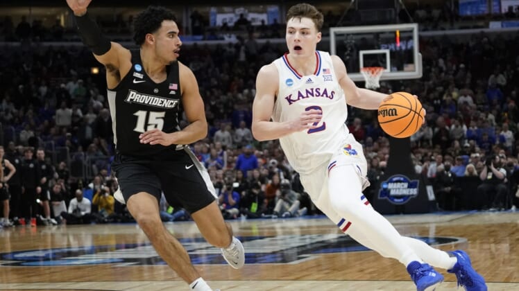 Mar 25, 2022; Chicago, IL, USA; Kansas Jayhawks guard Christian Braun (2) dribbles against Providence Friars forward Justin Minaya (15) during the second half in the semifinals of the Midwest regional of the men's college basketball NCAA Tournament at United Center. Mandatory Credit: David Banks-USA TODAY Sports