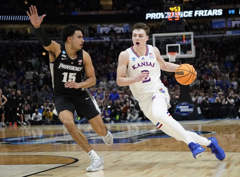 Mar 25, 2022; Chicago, IL, USA; Kansas Jayhawks guard Christian Braun (2) dribbles against Providence Friars forward Justin Minaya (15) during the second half in the semifinals of the Midwest regional of the men's college basketball NCAA Tournament at United Center. Mandatory Credit: David Banks-USA TODAY Sports
