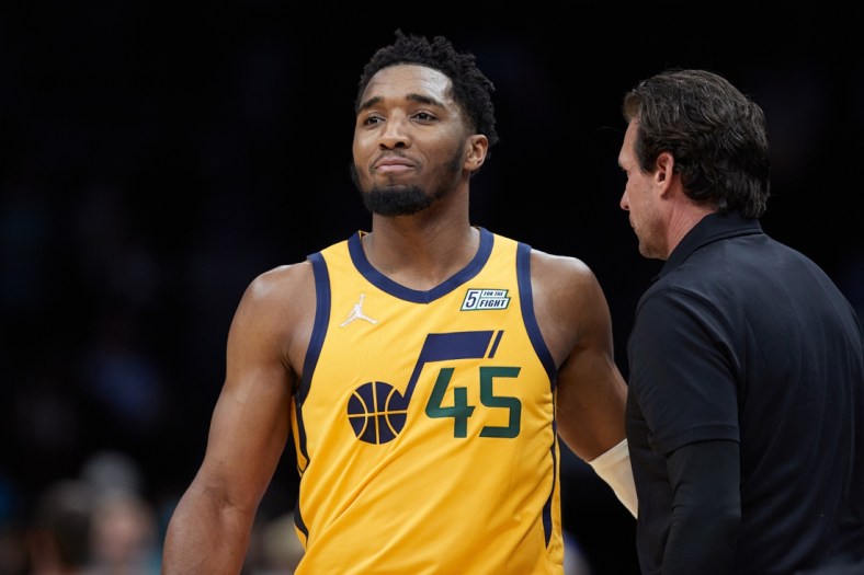 Mar 25, 2022; Charlotte, North Carolina, USA; Utah Jazz guard Donovan Mitchell (45) walks past head coach Quin Snyder during the fourth quarter against the Charlotte Hornets at Spectrum Center. Mandatory Credit: Brian Westerholt-USA TODAY Sports