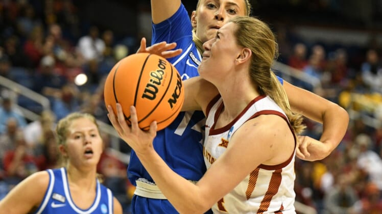 Mar 25, 2022; Greensboro, NC, USA; Iowa State Cyclones guard Ashley Joens (24) is fouled by Creighton Bluejays forward Mallory Brake (14) in the first quarter in the Greensboro regional semifinals of the women's college basketball NCAA Tournament at Greensboro Coliseum. Mandatory Credit: William Howard-USA TODAY Sports