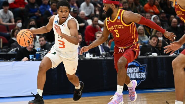 Mar 25, 2022; Chicago, IL, USA; Miami Hurricanes guard Charlie Moore (3) dribbles past Iowa State Cyclones guard Tre Jackson (3) during the first half in the semifinals of the Midwest regional of the men's college basketball NCAA Tournament at United Center. Mandatory Credit: Jamie Sabau-USA TODAY Sports