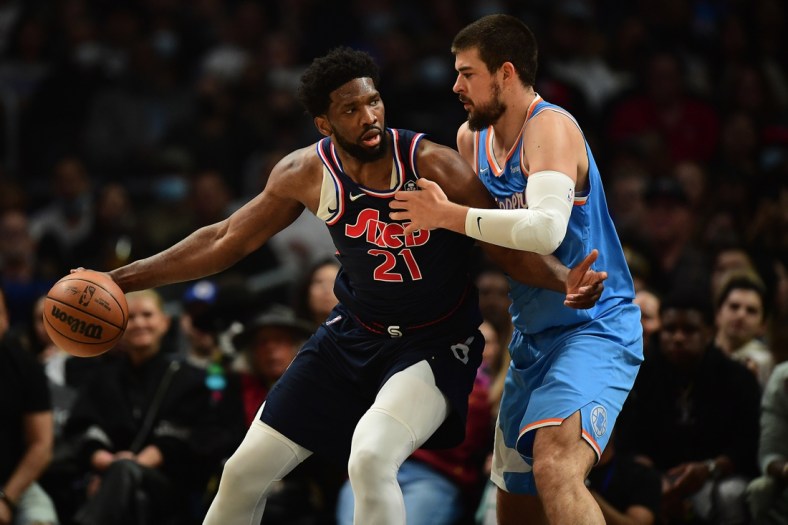 Mar 25, 2022; Los Angeles, California, USA; Philadelphia 76ers center Joel Embiid (21) moves the ball against Los Angeles Clippers center Ivica Zubac (40) during the first half at Crypto.com Arena. Mandatory Credit: Gary A. Vasquez-USA TODAY Sports