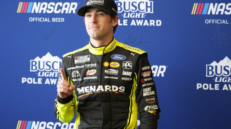 Mar 26, 2022; Austin, Texas, USA; NASCAR Cup Series driver Ryan Blaney (12) poses for photos after winning the pole award during the EchoPark Automotive Texas Grand Prix Qualifying at Circuit of the Americas. Mandatory Credit: Mike Dinovo-USA TODAY Sports