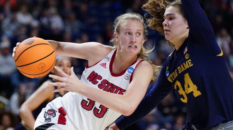 Mar 26, 2022; Bridgeport, CT, USA; NC State Wolfpack center Elissa Cunane (33) drives the ball against Notre Dame Fighting Irish forward Maddy Westbeld (34) in the first half at Webster Bank Arena. Mandatory Credit: David Butler II-USA TODAY Sports