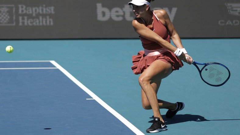 Mar 26, 2022; Miami Gardens, FL, USA; Belinda Bencic (SUI) hits a backhand against Heather Watson (GBR) (not pictured) in a women's singles third round match in the Miami Open at Hard Rock Stadium. Mandatory Credit: Geoff Burke-USA TODAY Sports