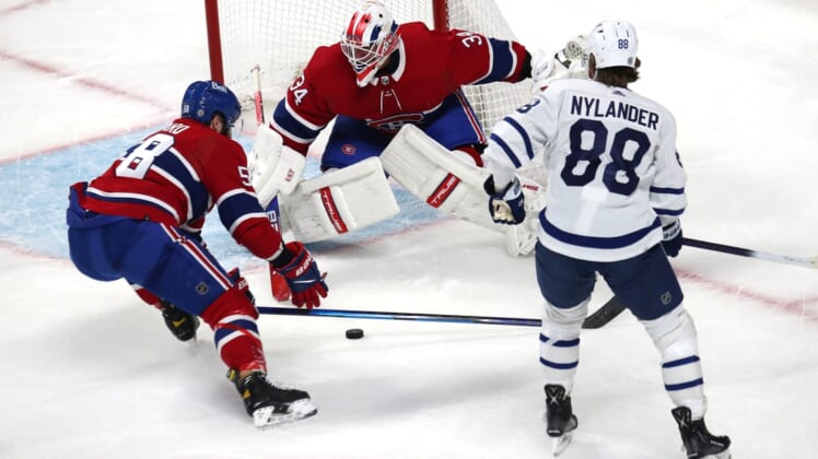 Mar 26, 2022; Montreal, Quebec, CAN; Montreal Canadiens defenseman David Savard (58) assists goaltender Jake Allen (34) with a save against Toronto Maple Leafs right wing William Nylander (88) during the first period at Bell Centre. Mandatory Credit: Jean-Yves Ahern-USA TODAY Sports