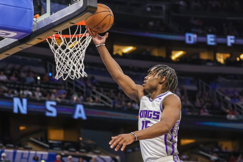 Mar 26, 2022; Orlando, Florida, USA; Sacramento Kings guard Davion Mitchell (15) goes to the basket during the second quarter against the Orlando Magic at Amway Center. Mandatory Credit: Mike Watters-USA TODAY Sports