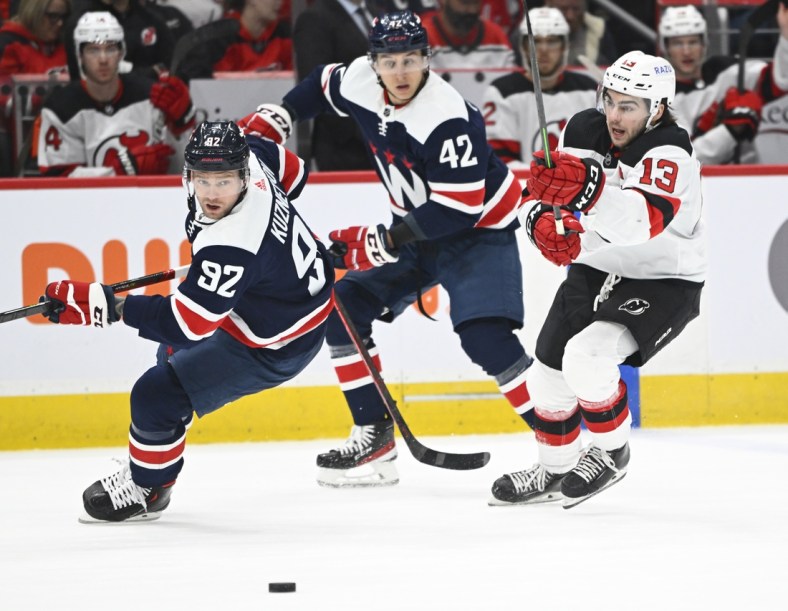 Mar 26, 2022; Washington, District of Columbia, USA; New Jersey Devils center Nico Hischier (13) and Washington Capitals center Evgeny Kuznetsov (92) track the puck during the second period at Capital One Arena. Mandatory Credit: Brad Mills-USA TODAY Sports