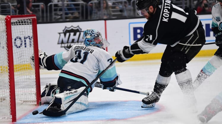 Mar 26, 2022; Los Angeles, California, USA; Los Angeles Kings center Anze Kopitar (11) scores a goal against Seattle Kraken goaltender Philipp Grubauer (31) during the second period at Crypto.com Arena. Mandatory Credit: Gary A. Vasquez-USA TODAY Sports