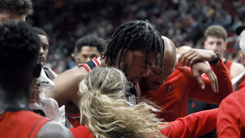 Mar 26, 2022; Portland, Oregon, USA; Portland Trail Blazers power forward Trendon Watford (2) is helped off the court following an injury in the fourth quarter against the Houston Rockets at Moda Center. Mandatory Credit: Soobum Im-USA TODAY Sports