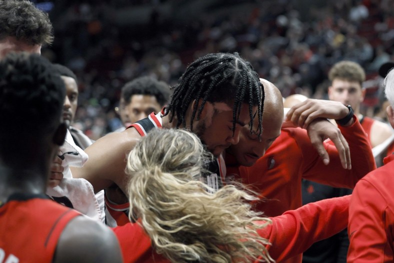Mar 26, 2022; Portland, Oregon, USA; Portland Trail Blazers power forward Trendon Watford (2) is helped off the court following an injury in the fourth quarter against the Houston Rockets at Moda Center. Mandatory Credit: Soobum Im-USA TODAY Sports