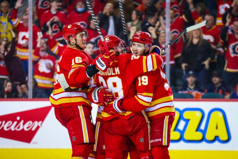 Mar 26, 2022; Calgary, Alberta, CAN; Calgary Flames center Elias Lindholm (28) celebrates his goal with teammates against the Edmonton Oilers during the third period at Scotiabank Saddledome. Mandatory Credit: Sergei Belski-USA TODAY Sports