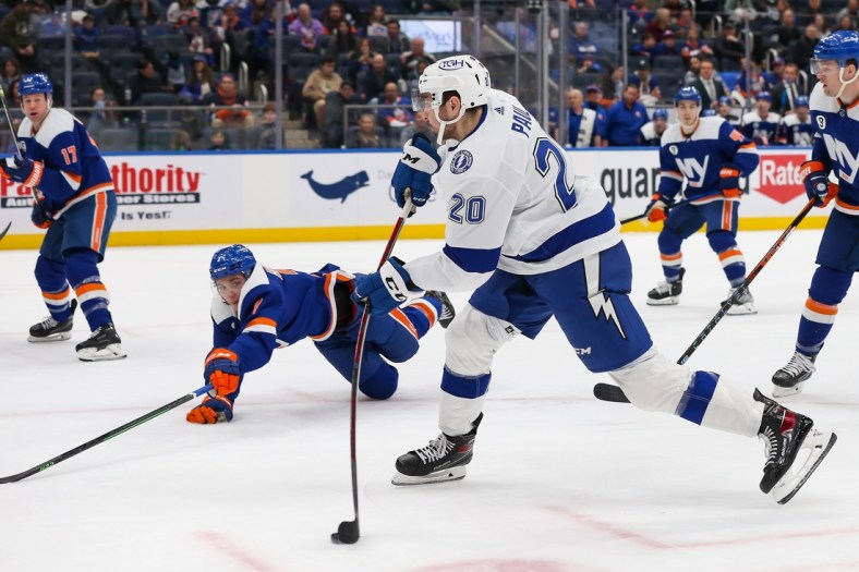 Mar 27, 2022; Elmont, New York, USA; Tampa Bay Lightning left wing Nicholas Paul (20) shoots the puck against New York Islanders during the first period at UBS Arena. Mandatory Credit: Tom Horak-USA TODAY Sports