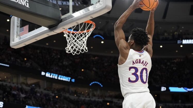 Mar 27, 2022; Chicago, IL, USA; Kansas Jayhawks guard Ochai Agbaji (30) dunks during the second half against the Miami Hurricanes in the finals of the Midwest regional of the men's college basketball NCAA Tournament at United Center. Mandatory Credit: David Banks-USA TODAY Sports