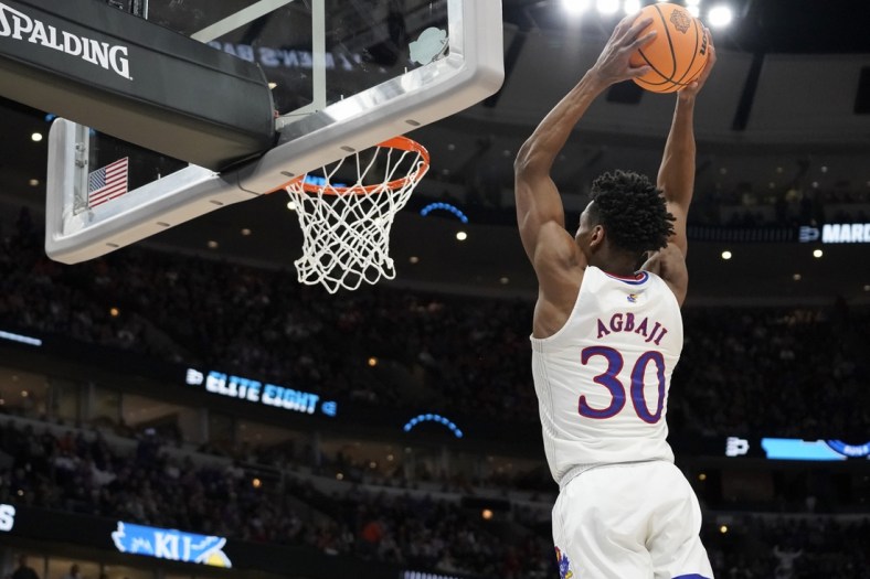 Mar 27, 2022; Chicago, IL, USA; Kansas Jayhawks guard Ochai Agbaji (30) dunks during the second half against the Miami Hurricanes in the finals of the Midwest regional of the men's college basketball NCAA Tournament at United Center. Mandatory Credit: David Banks-USA TODAY Sports