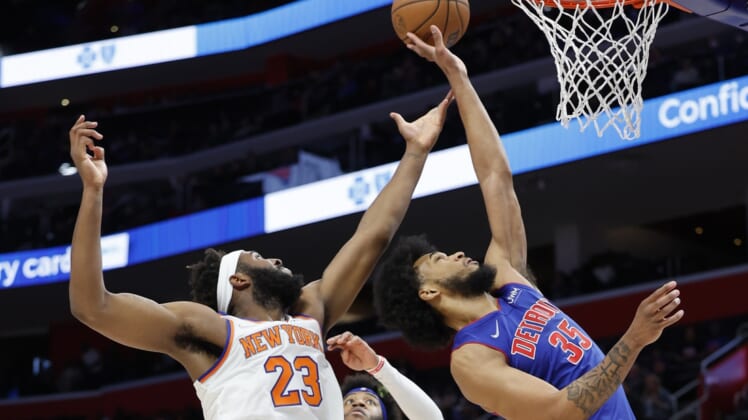 Mar 27, 2022; Detroit, Michigan, USA;  New York Knicks center Mitchell Robinson (23) and Detroit Pistons forward Marvin Bagley III (35) goes for the rebound in the first half at Little Caesars Arena. Mandatory Credit: Rick Osentoski-USA TODAY Sports