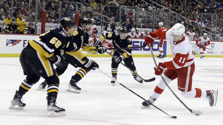 Mar 27, 2022; Pittsburgh, Pennsylvania, USA;  Detroit Red Wings right wing Filip Zadina (11) shoots the puck against the Pittsburgh Penguins during the first period at PPG Paints Arena. Mandatory Credit: Charles LeClaire-USA TODAY Sports