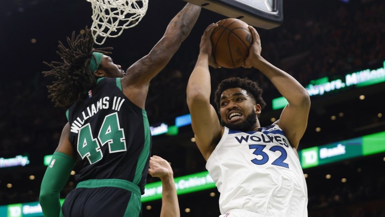 Mar 27, 2022; Boston, Massachusetts, USA; Minnesota Timberwolves center Karl-Anthony Towns (32) looks for a way around Boston Celtics center Robert Williams III (44) during the first quarter at TD Garden. Mandatory Credit: Winslow Townson-USA TODAY Sports