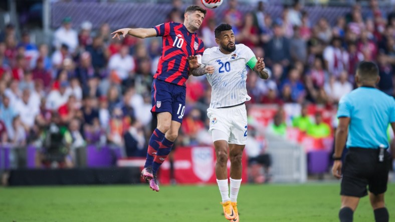 Mar 27, 2022; Orlando, Florida, USA; United States forward Christian Pulisic (10) battles for the ball against Panama midfielder Anibal Godoy (20) in the first half during a FIFA World Cup Qualifier soccer match at Exploria Stadium. Mandatory Credit: Jeremy Reper-USA TODAY Sports