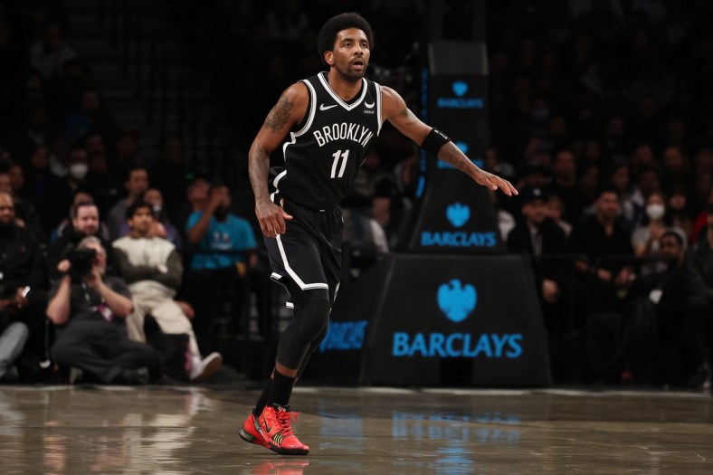 Mar 27, 2022; Brooklyn, New York, USA; Brooklyn Nets guard Kyrie Irving (11) looks on against the Charlotte Hornets during the first quarter at Barclays Center. Mandatory Credit: Vincent Carchietta-USA TODAY Sports