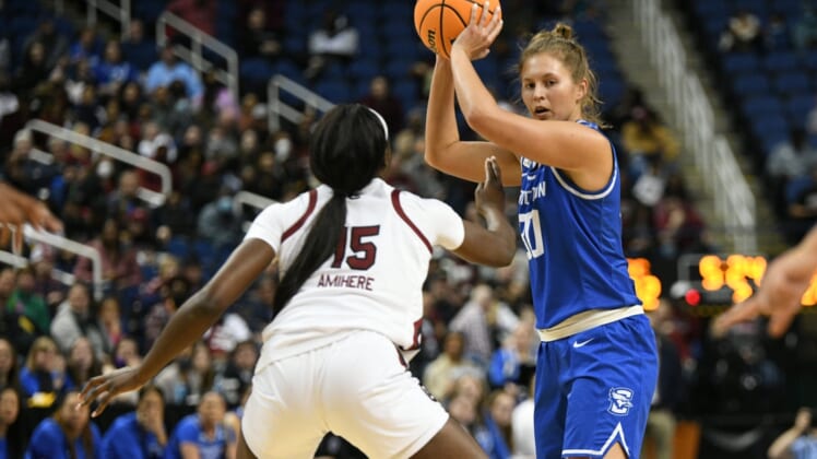 Mar 27, 2022; Greensboro, NC, USA; Creighton Bluejays guard Morgan Maly (30) looks under the basket with South Carolina Gamecocks forward Laeticia Amihere (15) guarding tightly in the second quarter in the Greensboro regional finals of the women's college basketball NCAA Tournament at Greensboro Coliseum. Mandatory Credit: William Howard-USA TODAY Sports