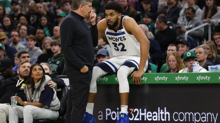 Mar 27, 2022; Boston, Massachusetts, USA; Minnesota Timberwolves head coach Chris Finch talks with center Karl-Anthony Towns (32) during the second half against the Boston Celtics at TD Garden. Mandatory Credit: Winslow Townson-USA TODAY Sports