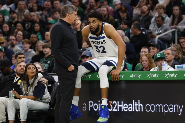 Mar 27, 2022; Boston, Massachusetts, USA; Minnesota Timberwolves head coach Chris Finch talks with center Karl-Anthony Towns (32) during the second half against the Boston Celtics at TD Garden. Mandatory Credit: Winslow Townson-USA TODAY Sports