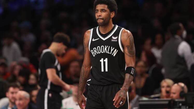 Mar 27, 2022; Brooklyn, New York, USA; Brooklyn Nets guard Kyrie Irving (11) walks on to the court after a time-out during the second half against the Charlotte Hornets at Barclays Center. Mandatory Credit: Vincent Carchietta-USA TODAY Sports
