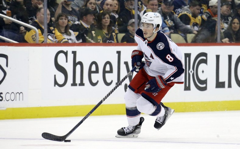 Mar 22, 2022; Pittsburgh, Pennsylvania, USA;  Columbus Blue Jackets defenseman Zach Werenski (8) skates with the puck against the Pittsburgh Penguins during the first period at PPG Paints Arena. Mandatory Credit: Charles LeClaire-USA TODAY Sports