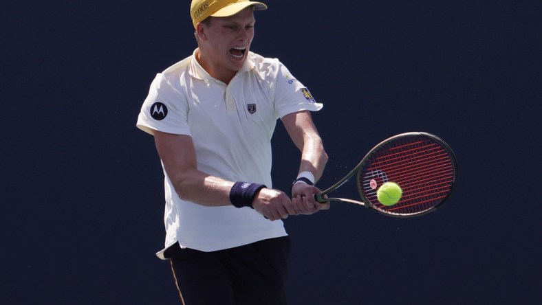 Mar 28, 2022; Miami Gardens, FL, USA; Jenson Brooksby (USA) hits a backhand against Roberto Bautista Agut (ESP)(not pictured) in a third round men's singles match in the Miami Open at Hard Rock Stadium. Mandatory Credit: Geoff Burke-USA TODAY Sports