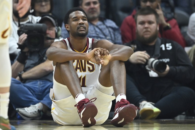 Mar 28, 2022; Cleveland, Ohio, USA; Cleveland Cavaliers center Evan Mobley (4) reacts after he was knocked to the floor in the second quarter against the Orlando Magic at Rocket Mortgage FieldHouse. Mandatory Credit: David Richard-USA TODAY Sports
