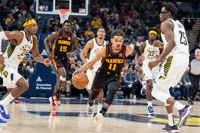Mar 28, 2022; Indianapolis, Indiana, USA; Atlanta Hawks guard Trae Young (11) dribbles the ball in the first half against the Indiana Pacers at Gainbridge Fieldhouse. Mandatory Credit: Trevor Ruszkowski-USA TODAY Sports