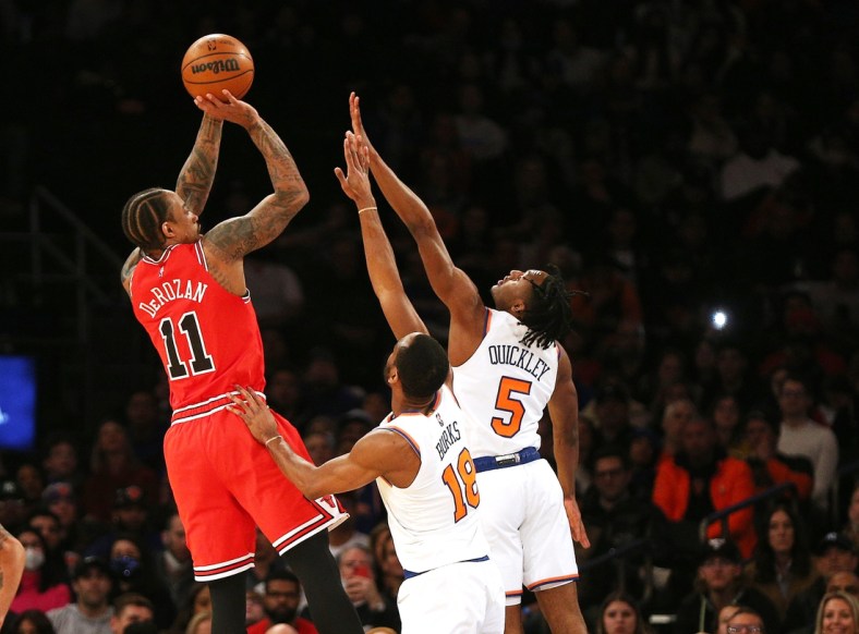 Mar 28, 2022; New York, New York, USA: Chicago Bulls forward DeMar DeRozan (11) shoots against New York Knicks guard Alec Burks (18) and guard Immanuel Quickley (5) during the first half at Madison Square Garden. Mandatory Credit: Andy Marlin-USA TODAY Sports