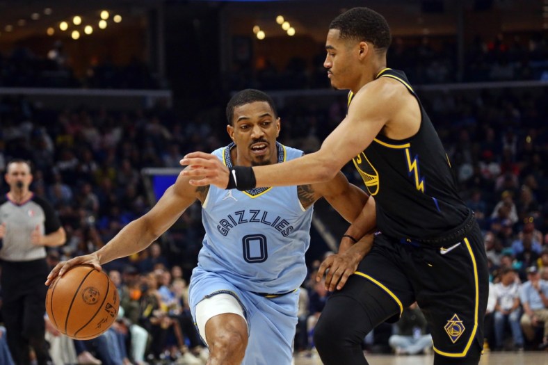 Mar 28, 2022; Memphis, Tennessee, USA; Memphis Grizzlies guard De'Anthony Melton (0) drives to the basket as Golden State Warriors guard Jordan Poole (3) defends during the first half at FedExForum. Mandatory Credit: Petre Thomas-USA TODAY Sports